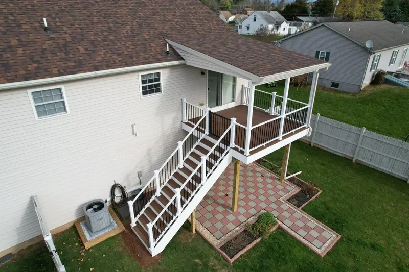 Elevated deck with full staircase and aluminum balusters — Caliber Build · 02