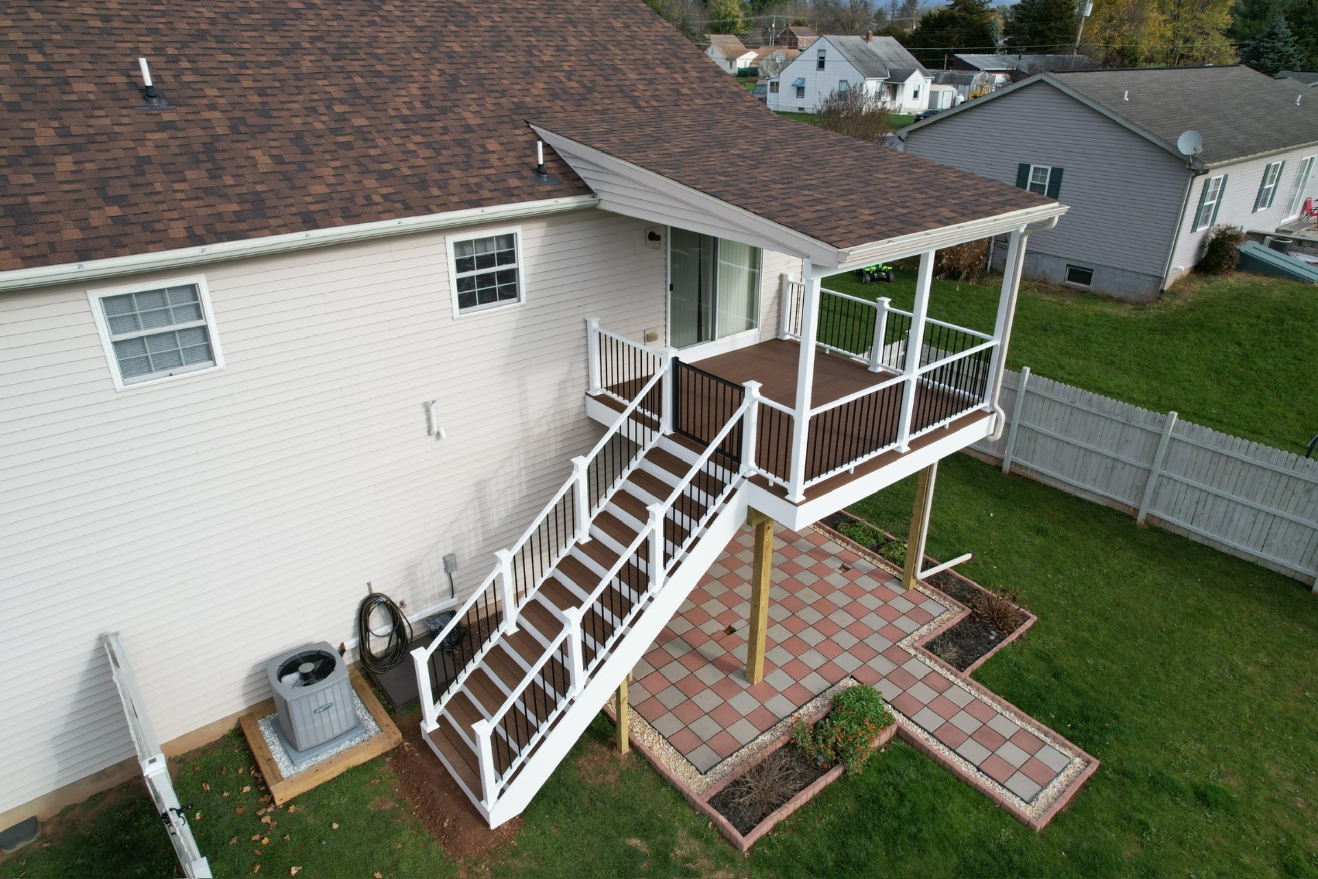 Elevated deck with full staircase and aluminum balusters — Caliber Build · 02
