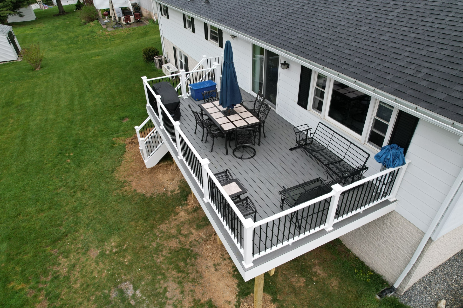 Custom deck build with dining and lounge area — Caliber Build · 05