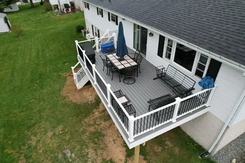 Custom deck build with dining and lounge area — Caliber Build · 05