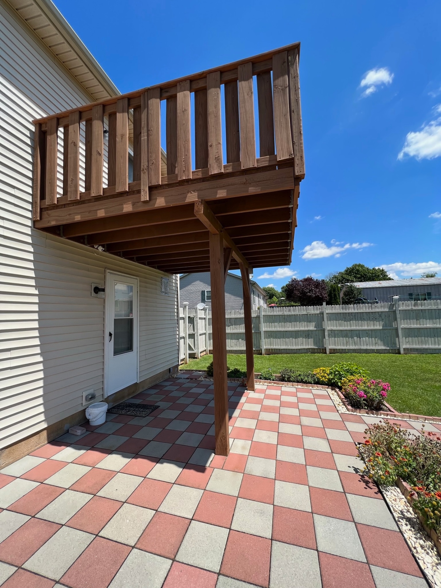 Before — original wood second-story deck and patio — Caliber Build · 07