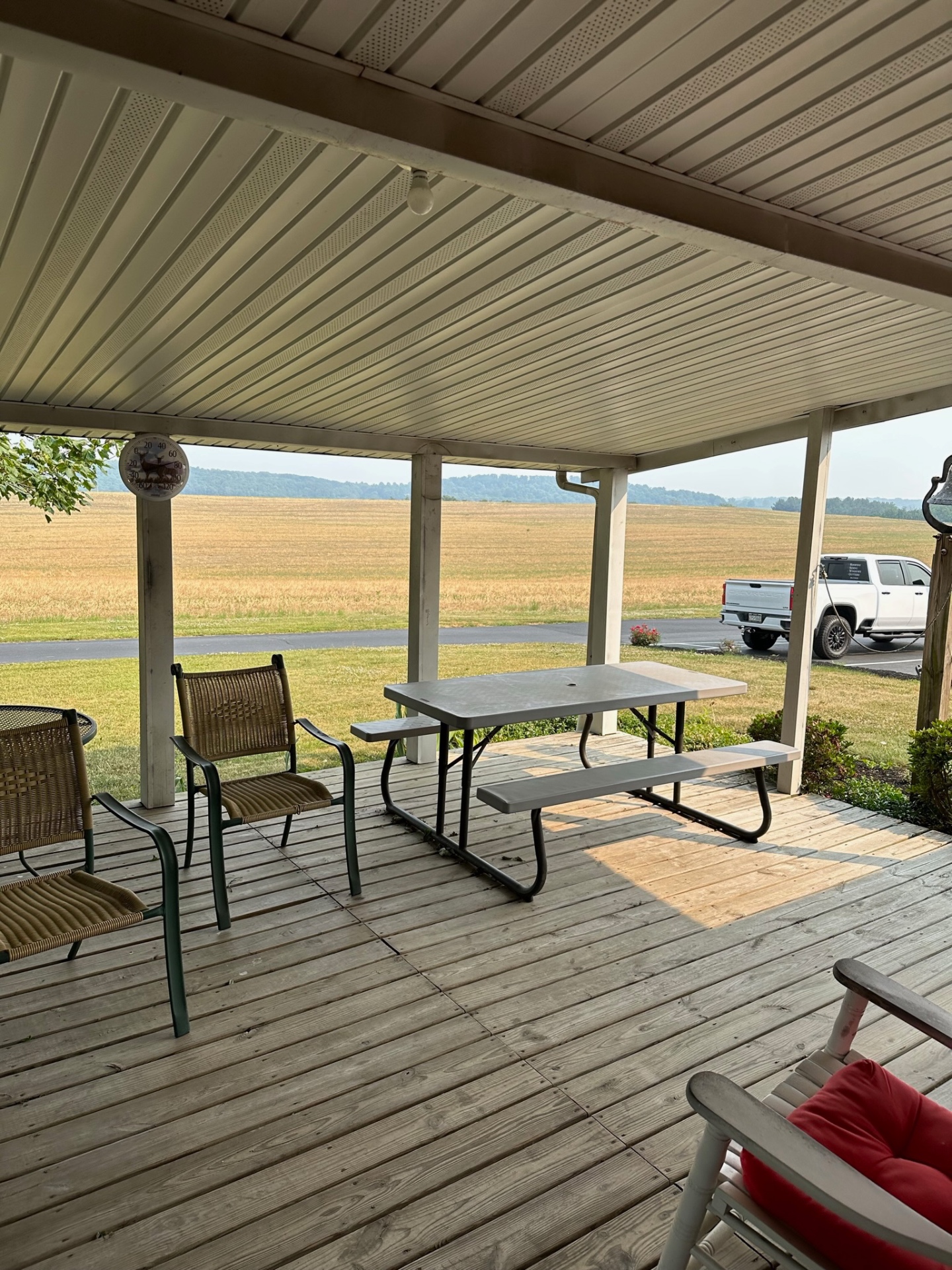 Covered porch deck with countryside view — Caliber Build · 09