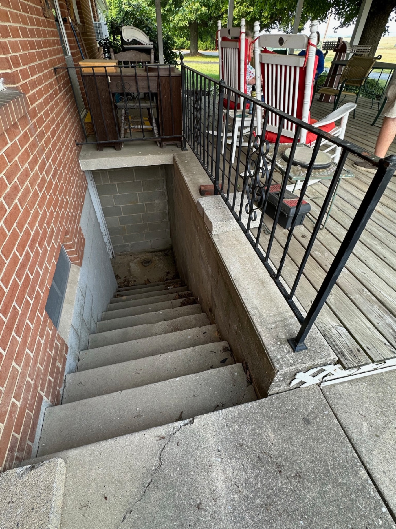 Before — original wood porch and basement entry — Caliber Build · 10